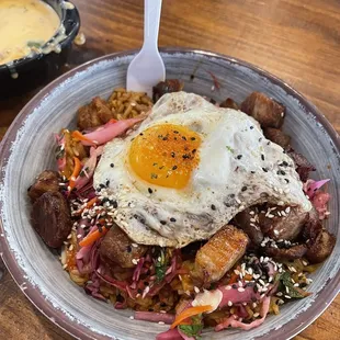 Nuri&apos;s bowl. It was delicious! I got mine with carnitas , white rice, kimchi, pickled onions, and an egg.