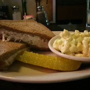 a plate of food with a sandwich and a pickle
