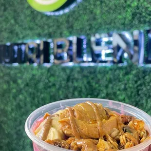 a hand holding a cup of nutrify