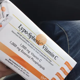 a hand holding a box of vitamin c