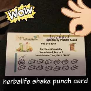 a hand holding a business card