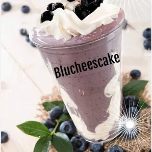 a blueberry smoothie with whipped cream and blueberries