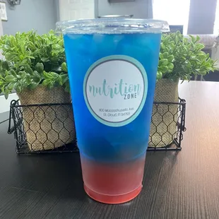 a blue and red drink on a table