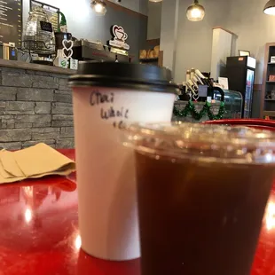 a cup of coffee on a red table