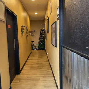 a hallway with a bicycle in the background