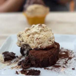 a piece of chocolate cake with a scoop of ice cream on top