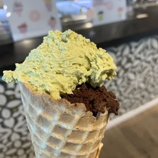 Dark chocolate ice cream with a small topper scoop of pistachio gelato in house made waffle cone!  So good and creamy!