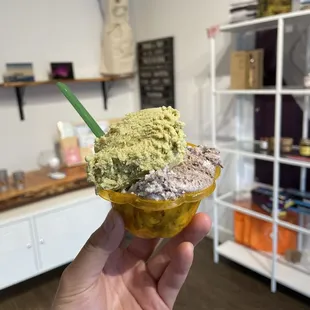 a hand holding a gelato