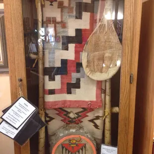 Great display with historic blanket and tools, with informational description.