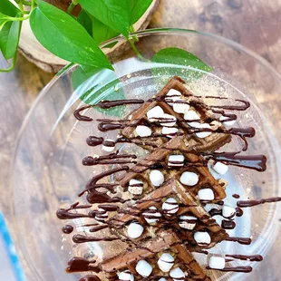 Chocolate Belgian Waffle with chocolate drizzle, graham crackers and mini marshmallows.