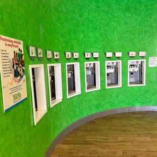 a green wall with pictures on it