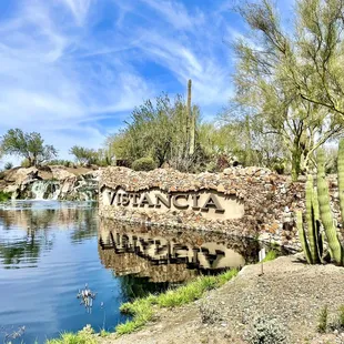 the name of arizona written on a rock wall next to a body of water