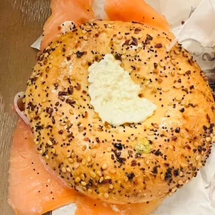 a bagel with cheese and salmon