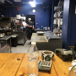 Both employees are not wearing masks or gloves