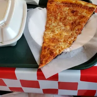 a slice of cheese pizza on a tray