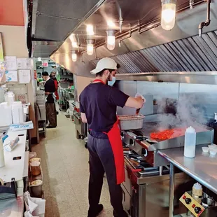 a man cooking in a commercial kitchen