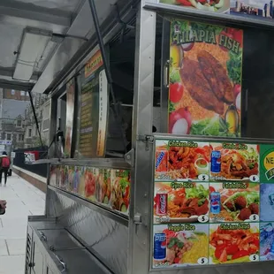 a woman standing in front of a food cart