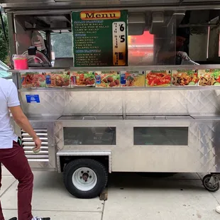 a man standing in front of a food truck