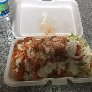 Chicken over rice with sauces, falafel, and chickpeas. $5 exactly w/drink. Kinda messy looking but that&apos;s my error, not theirs.