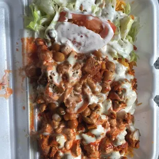 Chicken over rice with sauces, falafel, and chickpeas. $5 exactly w/drink. Kinda messy looking but that&apos;s my error, not theirs.