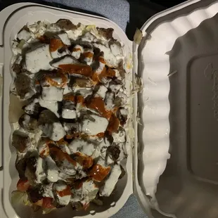 Amazing lamb over rice and salad with both white and sauces. Truly awesome