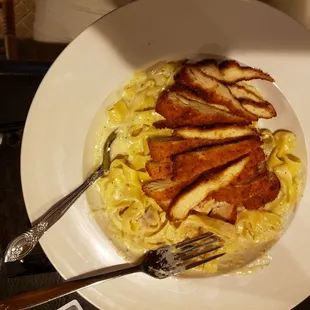 a plate of chicken and noodles