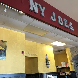 Wine bottles, paintings, and restrooms.