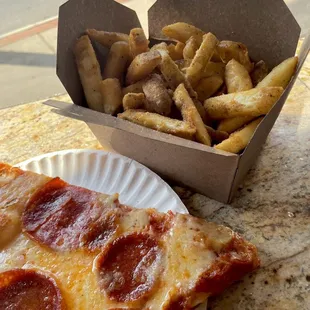 a slice of pepperoni pizza and french fries