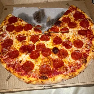 a half eaten pepperoni pizza