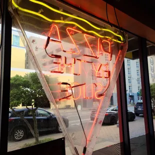 a neon sign in the window of a restaurant