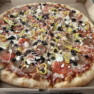 Mediterranean Pizza with sausage &amp; onions added. Delivered through Uber Eats. Crust was flavorless and doughy under the cheese.