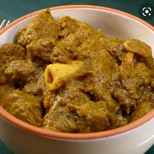 This is authentic curry goat. Goat bones are thick often slightly golden due to the curry and hollow in the middle.