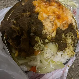 Curry goat, mac n cheese, white rice, and cabbage