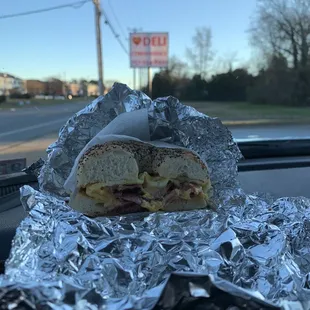 a sandwich wrapped in aluminum foil