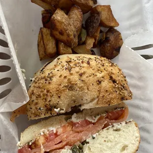Everything bagel with lox, cream cheese and capers. Home fries on the side.