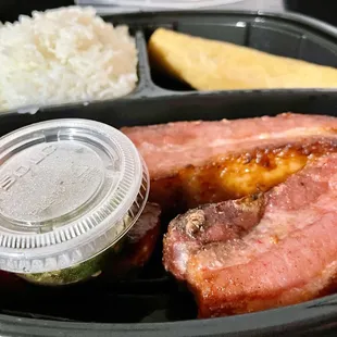 Pork belly entree with an eggroll and spicy chili pepper dip