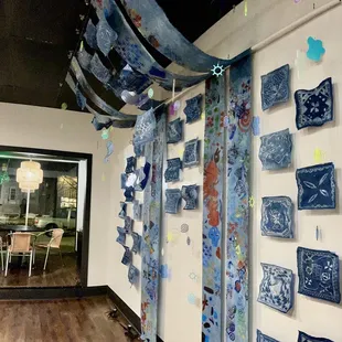 blue and white plates hanging from the ceiling