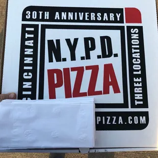 a person holding a pizza box