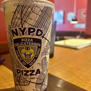 a cup of pizza on a table