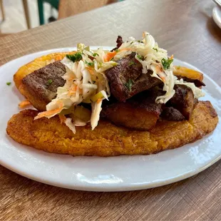 Plantains with fried pork &amp; pikliz