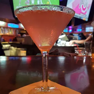 a pink drink in a martini glass
