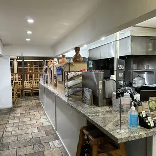 a kitchen with a counter and stools
