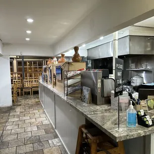 a kitchen with a counter and stools