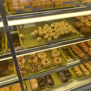 a variety of donuts in a display case