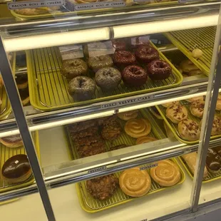 a variety of donuts in a display case
