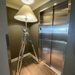a tripod and a lamp in a hallway