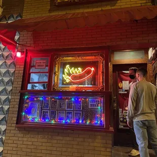 a man standing in front of a restaurant