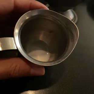  hand holding a measuring cup