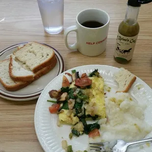 A beautiful veggie omelet, with spinach, avocado on the side, and grits, they even had gluten free toast. Awesome!