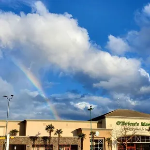 Storefront of O&apos;Brien&apos;s Market with a rainbow in the sky! :)